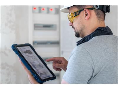 electrical-technician-looking-focused-while-working-switchboard-with-fuses.jpg